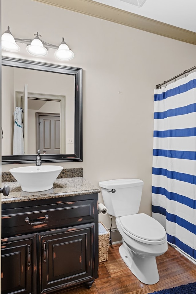 bathroom featuring hardwood / wood-style flooring, vanity, and toilet