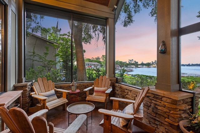 sunroom featuring a water view and a wealth of natural light