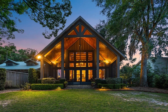 back house at dusk with a yard