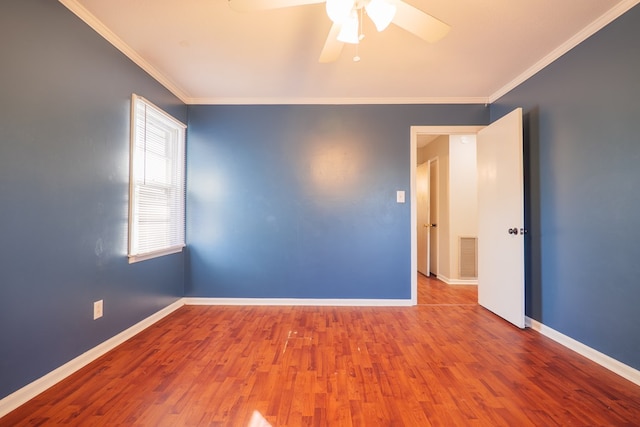 spare room with hardwood / wood-style flooring, ornamental molding, and ceiling fan