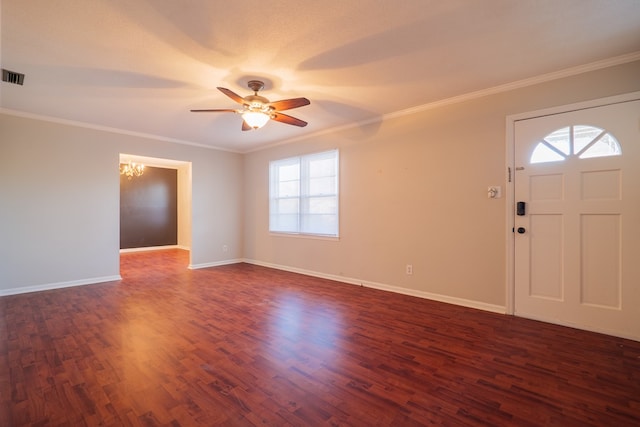 foyer with crown molding, dark wood-type flooring, and ceiling fan with notable chandelier