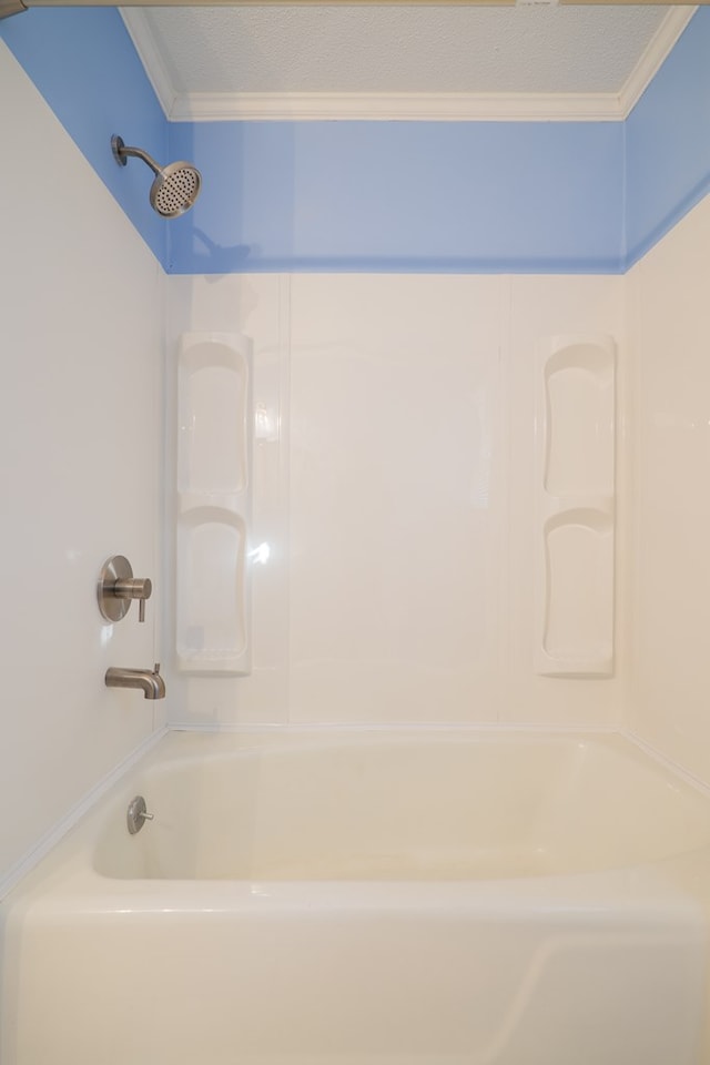 bathroom featuring ornamental molding and  shower combination