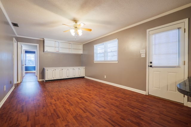 interior space with ceiling fan, ornamental molding, a textured ceiling, and dark hardwood / wood-style flooring