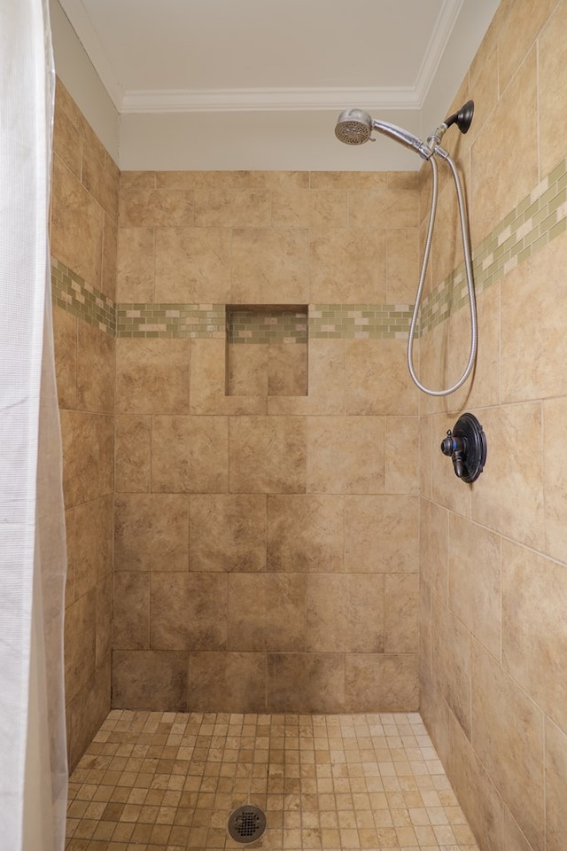 bathroom featuring ornamental molding and a shower with shower curtain