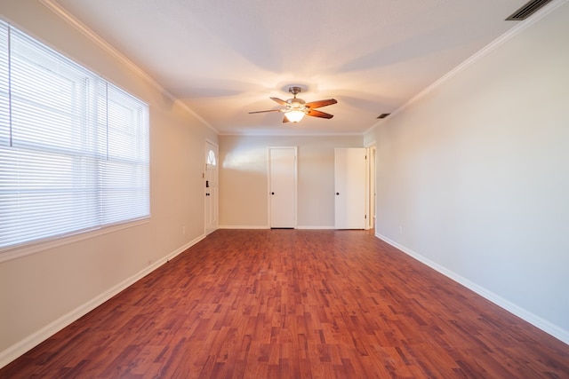 empty room featuring crown molding, ceiling fan, and dark hardwood / wood-style flooring