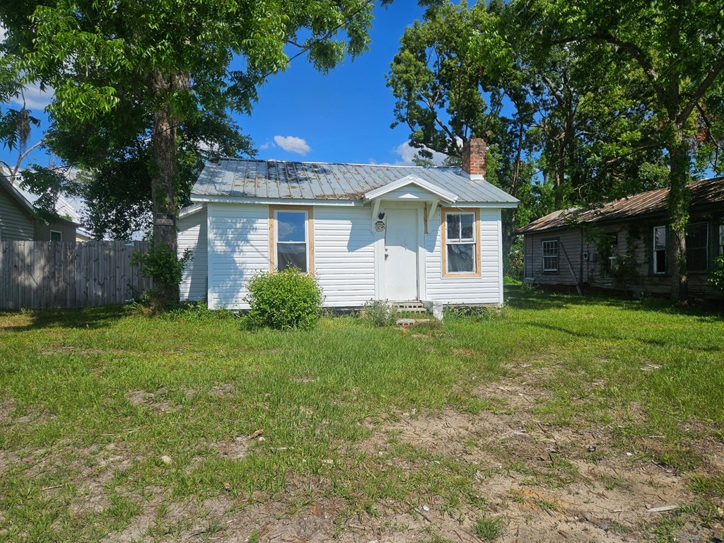 201 Beetree Ave, Nashville, GA 31639 - view of front of house featuring metal roof, a chimney, and an outdoor structure