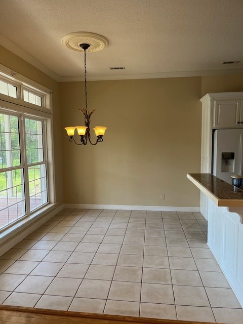 5054 Hammock Trl, Lake Park, GA 31636 - unfurnished dining area with ornamental molding, a textured ceiling, a chandelier, baseboards, and light tile patterned floors