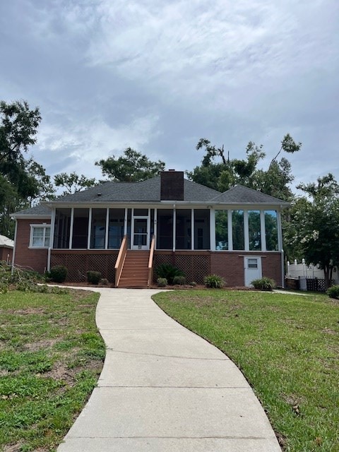 5054 Hammock Trl, Lake Park, GA 31636 - ranch-style house with a sunroom, brick siding, a front lawn, and a chimney