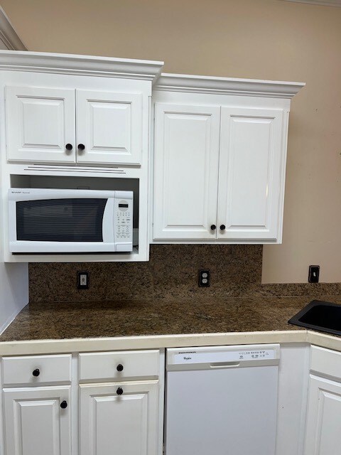 5054 Hammock Trl, Lake Park, GA 31636 - kitchen featuring white appliances, white cabinets, tile counters, and a sink