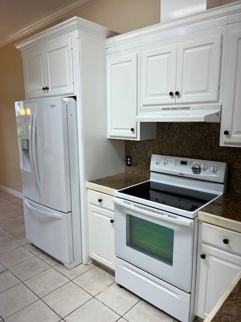 5054 Hammock Trl, Lake Park, GA 31636 - kitchen featuring white appliances, under cabinet range hood, dark countertops, white cabinetry, and light tile patterned flooring