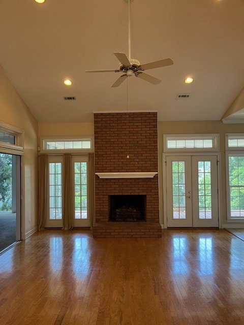 5054 Hammock Trl, Lake Park, GA 31636 - unfurnished living room with high vaulted ceiling, ceiling fan, wood finished floors, a brick fireplace, and recessed lighting