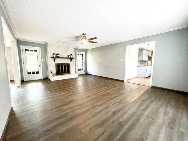 unfurnished living room with a fireplace, wood-type flooring, and plenty of natural light