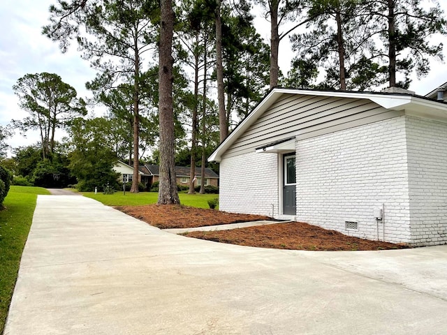 view of side of property with a yard