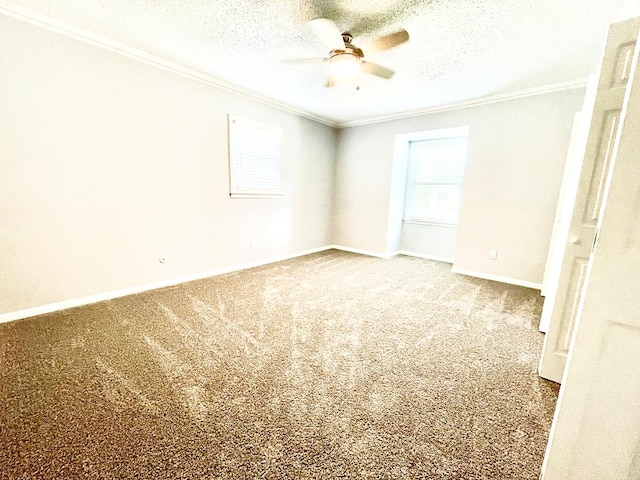 carpeted spare room featuring ornamental molding, ceiling fan, and a textured ceiling