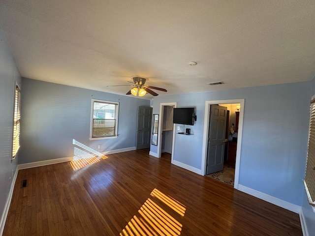 empty room featuring ceiling fan and dark wood-type flooring