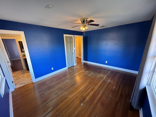 unfurnished bedroom with ceiling fan and dark hardwood / wood-style flooring