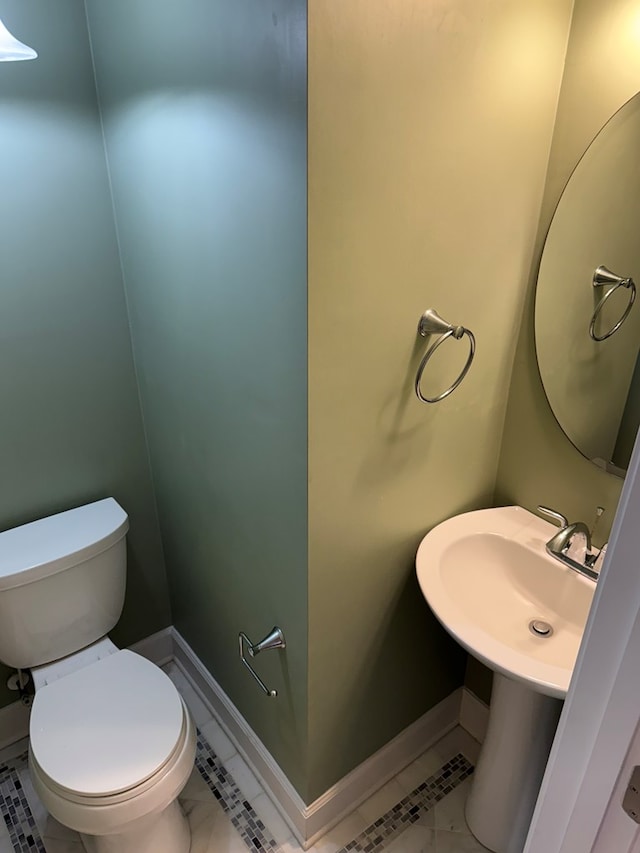 bathroom with tile patterned flooring and toilet