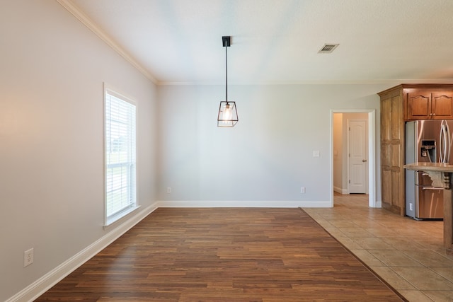 247 Harlee Ln, Ray City, GA 31645 - unfurnished dining area featuring healthy amount of natural light, crown molding, and light wood-type flooring