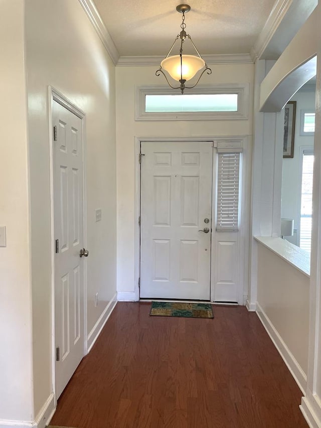 foyer entrance with crown molding and dark hardwood / wood-style flooring