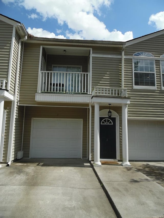 2502B Jerry Jones Dr Unit 3, Valdosta, GA 31602 - view of front facade with concrete driveway, an attached garage, and a balcony