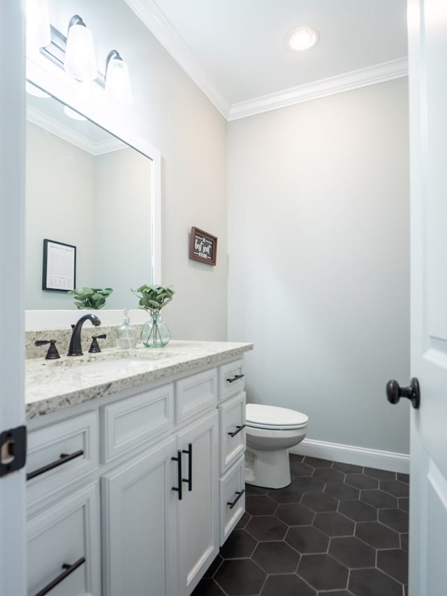 bathroom with vanity, tile patterned floors, ornamental molding, and toilet