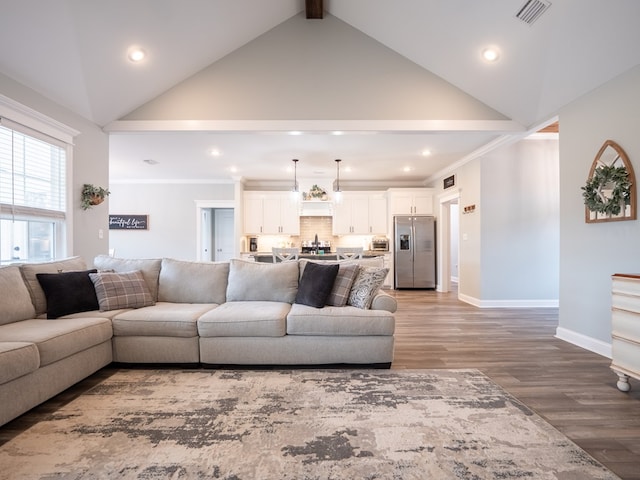 living room with hardwood / wood-style flooring, ornamental molding, high vaulted ceiling, and beamed ceiling