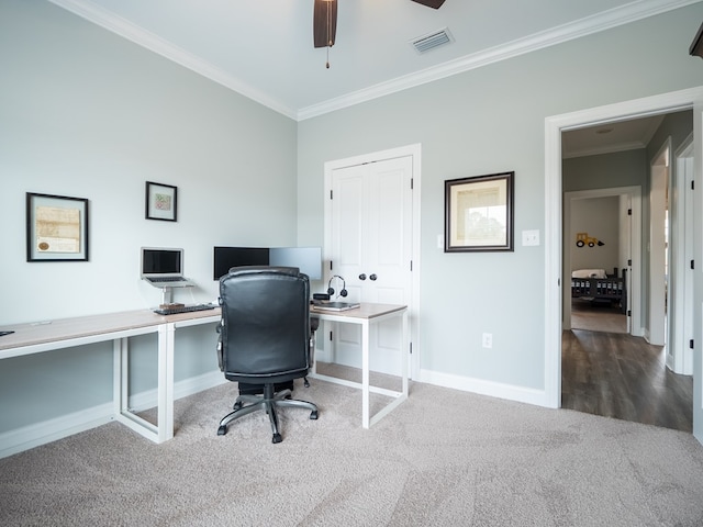 home office with crown molding, ceiling fan, and carpet