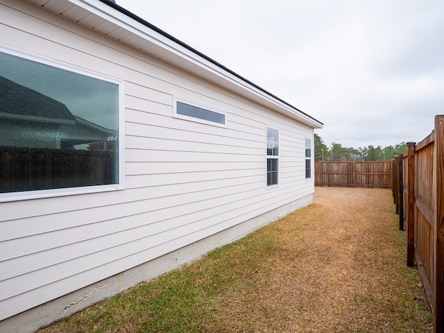 view of property exterior with a lawn