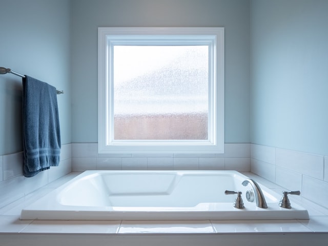 bathroom with tiled bath