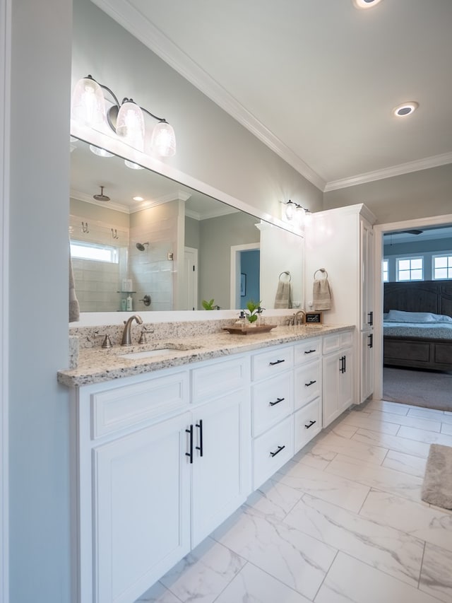 bathroom with crown molding, vanity, and walk in shower