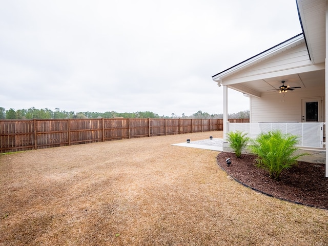 view of yard featuring a patio and ceiling fan