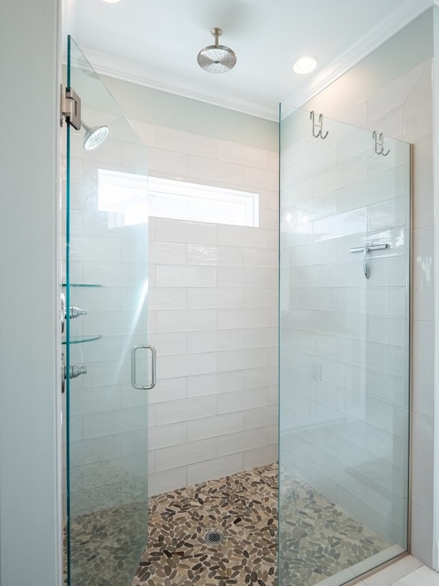 bathroom featuring crown molding and walk in shower