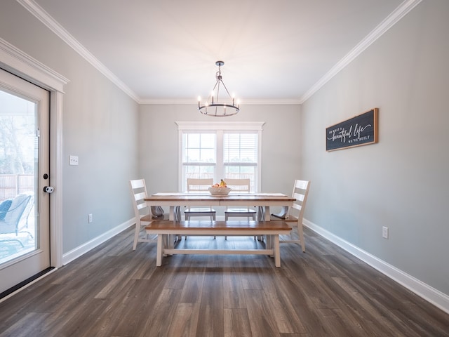 dining area with ornamental molding, a notable chandelier, and dark hardwood / wood-style flooring