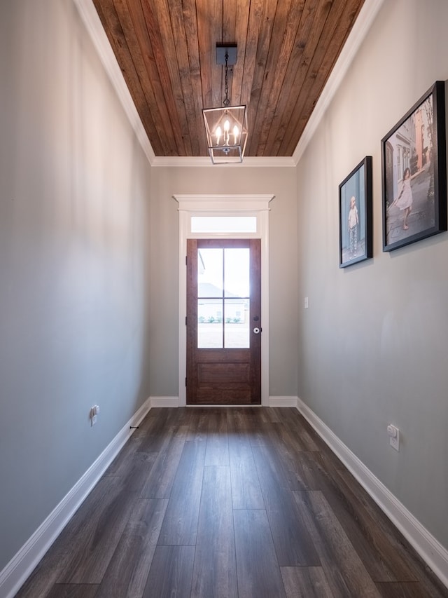 doorway to outside with a notable chandelier, dark wood-type flooring, wooden ceiling, and ornamental molding