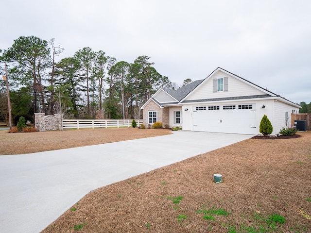 view of front of property featuring a garage and central air condition unit