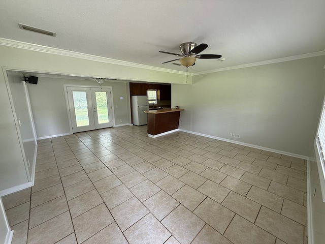 208 Magnolia Dr, Adel, GA 31620 - unfurnished living room with a ceiling fan, ornamental molding, light tile patterned floors, and french doors