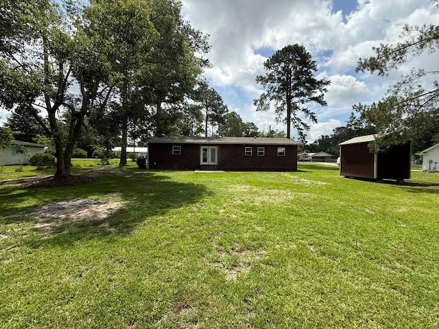 208 Magnolia Dr, Adel, GA 31620 - view of green lawn featuring a storage unit