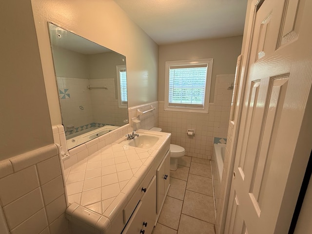 208 Magnolia Dr, Adel, GA 31620 - full bathroom featuring tile walls, tile patterned flooring, vanity, wainscoting, and shower / bathtub combination
