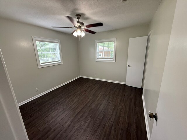 208 Magnolia Dr, Adel, GA 31620 - spare room featuring dark wood-style flooring, a textured ceiling, and ceiling fan