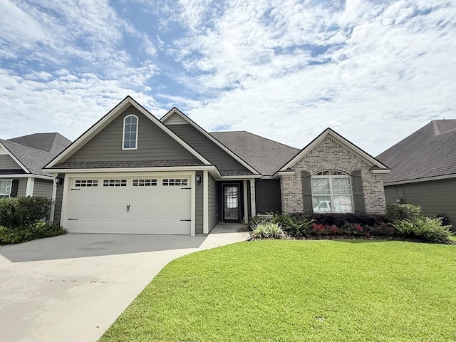 4172 Bright Crk, Hahira, GA 31632 - view of front of home featuring driveway, a front lawn, a garage, brick siding, and roof with shingles