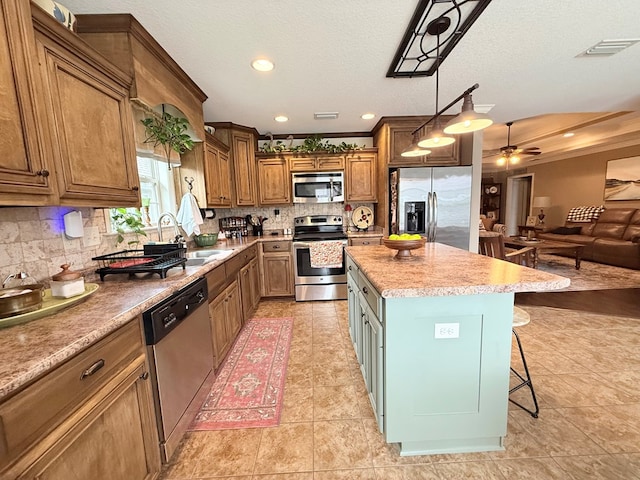 4172 Bright Crk, Hahira, GA 31632 - kitchen featuring appliances with stainless steel finishes, tasteful backsplash, a center island, a breakfast bar area, and ceiling fan