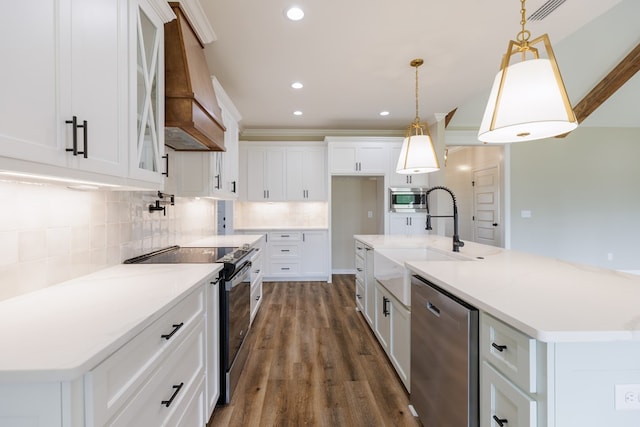 3061 Houser Way, Hahira, GA 31632 - kitchen featuring stainless steel appliances, a sink, premium range hood, white cabinetry, and recessed lighting