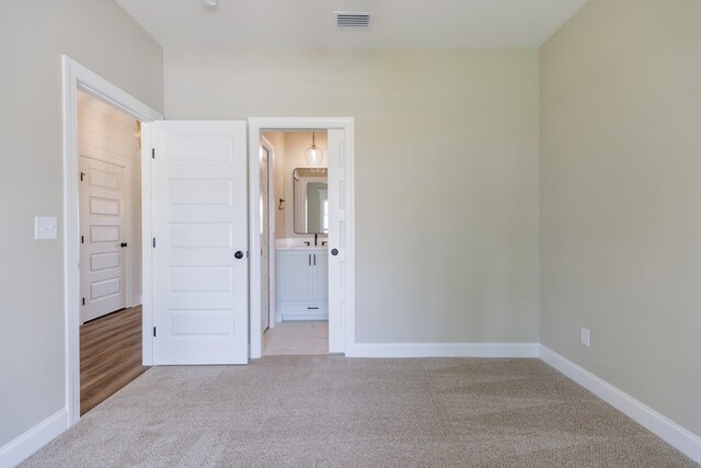 3061 Houser Way, Hahira, GA 31632 - unfurnished bedroom featuring carpet floors, baseboards, ensuite bath, and a sink