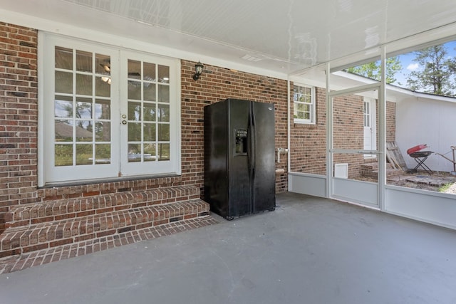 unfurnished sunroom with french doors