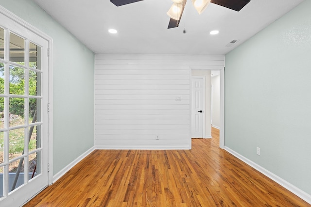 empty room with baseboards, a ceiling fan, recessed lighting, and wood finished floors