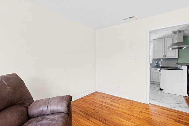 sitting room with baseboards, visible vents, and marble finish floor