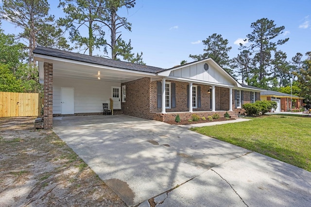 single story home featuring board and batten siding, brick siding, fence, a front lawn, and concrete driveway