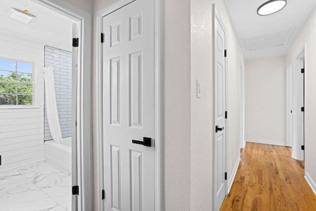 hall featuring baseboards