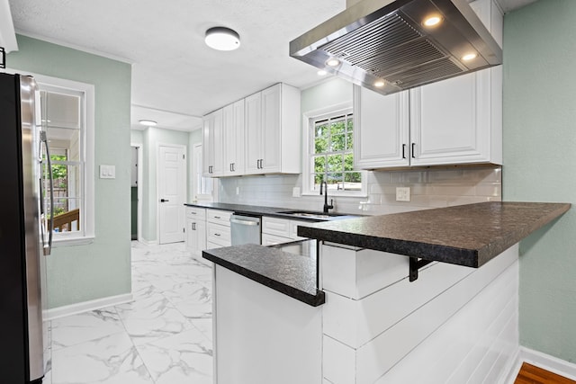 kitchen with baseboards, a sink, dark countertops, and ventilation hood