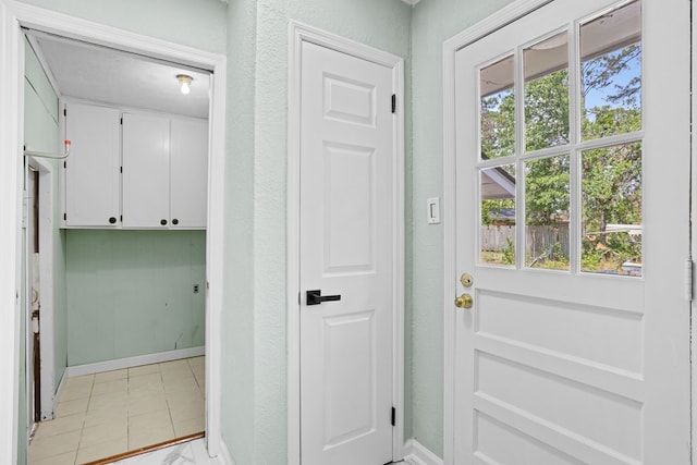 doorway featuring baseboards